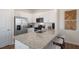 Bright, open kitchen featuring white shaker cabinets, stainless appliances, and a granite island at 447 Belgian Red Way, Wake Forest, NC 27587