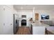 Modern kitchen featuring white shaker cabinets, stainless appliances, and a large granite-topped island at 447 Belgian Red Way, Wake Forest, NC 27587