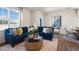 Cozy living room with large windows, comfortable blue sectional, and modern decor at 447 Belgian Red Way, Wake Forest, NC 27587