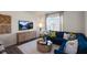 Inviting living area with a plush blue sectional sofa, stylish coffee table, and decorative accents at 447 Belgian Red Way, Wake Forest, NC 27587
