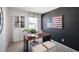 Modern home office with an American flag, a wooden desk, and a view outside at 447 Belgian Red Way, Wake Forest, NC 27587