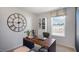 Home office with a large clock, wooden desk, and view of the community at 447 Belgian Red Way, Wake Forest, NC 27587