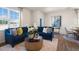 Cozy living room with a large sectional, decorative accents, and natural light from the window at 449 Belgian Red Way, Wake Forest, NC 27587