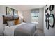 Bedroom with a gray comforter, unique headboard, and decorative mirrors at 466 Belgian Red Way, Wake Forest, NC 27587