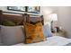 Close-up of a bedroom featuring a stylish bed with decorative pillows and artwork at 466 Belgian Red Way, Wake Forest, NC 27587