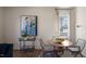 Charming dining area with a round wooden table, wicker chairs, and large window at 466 Belgian Red Way, Wake Forest, NC 27587
