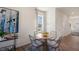 Dining area with a round wooden table and four wicker chairs at 466 Belgian Red Way, Wake Forest, NC 27587
