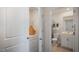 View of the laundry area and a hallway bathroom with white cabinetry at 466 Belgian Red Way, Wake Forest, NC 27587