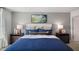 A cozy main bedroom with a blue comforter, matching pillows, and bedside tables at 466 Belgian Red Way, Wake Forest, NC 27587