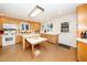 Kitchen with light wood cabinetry, white appliances, and an island, offering ample counter space at 4921 Larchmont Dr, Raleigh, NC 27612