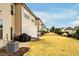 View of the backyard and neighboring townhomes, with landscaping and privacy fences at 7707 Weathered Oak Way Way, Raleigh, NC 27616