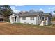 White brick ranch home with sunroom and covered entryway at 900 Roxboro Road, Oxford, NC 27565