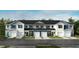 Attractive townhomes with garages, white and blue siding, and green landscaping at 10554 Brookside Reserve Rd, Raleigh, NC 27614