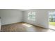 Living Room with wood-look flooring, large window, and sliding glass door to the backyard at 110 Victory Ln, Durham, NC 27703