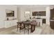 Bright dining area with wood table and chairs, adjacent to kitchen at 112 S Stone Mill Trl # 232, Clayton, NC 27520