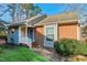 Brick and gray siding home with walkway and landscaping at 115 Clancy Cir, Cary, NC 27511