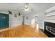 Hardwood floor living room with fireplace and view of kitchen and front door at 116 Drew Ct, Clayton, NC 27520