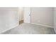 Empty bedroom with gray carpet, white walls, and open door at 121 Candlewick Dr, Wendell, NC 27591