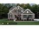 Two-story home with stone and brick exterior and a landscaped yard at 259 August Trce Dr, Pittsboro, NC 27312