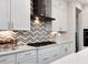 Modern kitchen features with white cabinets and a statement backsplash at 259 August Trce Dr, Pittsboro, NC 27312