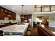 Gourmet kitchen with granite countertops, island seating, and dark wood cabinets at 259 August Trce Dr, Pittsboro, NC 27312
