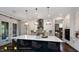 Modern kitchen with island, white cabinets, and a dark blue island at 259 August Trce Dr, Pittsboro, NC 27312