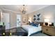 Main bedroom with plush bed, wooden nightstands, and view to bathroom at 259 August Trce Dr, Pittsboro, NC 27312