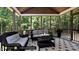 Relaxing screened porch with wicker furniture and wooded views at 259 August Trce Dr, Pittsboro, NC 27312