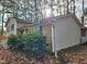 Side view of a two-story home with shrubs and a leaf-covered ground at 1305 Timber Dr, Garner, NC 27529