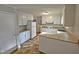 Kitchen with white cabinets, white appliances, and tile flooring at 1305 Timber Dr, Garner, NC 27529