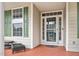 Front entrance with green door and sidelights, leading to a spacious porch at 1308 Fenwick Pkwy, Durham, NC 27713