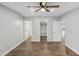 Well-lit bedroom showcasing wood-look floors and access to multiple rooms at 137 Kathleen Rd, Lillington, NC 27546