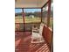 Screened-in back porch with rocking chairs and a view of the yard at 150 Water Oak Dr, Smithfield, NC 27577