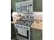 Close-up of white microwave and stove with green cabinets at 150 Water Oak Dr, Smithfield, NC 27577