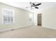 Bedroom with carpet, ceiling fan, two windows, and a walk-in closet at 2057 Tordelo Pl Pl, Apex, NC 27502