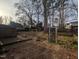 Backyard with a storage shed, wooden deck, swing set, and trees at 2705 Royster St, Raleigh, NC 27608