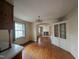 Dining room with hardwood floors and a view into the living room with a fireplace at 2705 Royster St, Raleigh, NC 27608