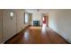 Living room featuring hardwood floors, fireplace, built-in shelves, and arched doorway at 2705 Royster St, Raleigh, NC 27608