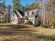 Two-story house with beige siding, a two-car garage, and a landscaped yard at 347 Manchester Trl, Clayton, NC 27527