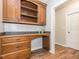 Built-in kitchen desk with wood cabinets and granite countertop at 347 Manchester Trl, Clayton, NC 27527