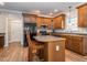 Kitchen with dark wood cabinets, an island, and black appliances at 347 Manchester Trl, Clayton, NC 27527