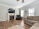 Living room with hardwood floors, fireplace, and comfy seating at 347 Manchester Trl, Clayton, NC 27527