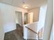 Upstairs hallway with carpeted floors and doors leading to various rooms at 404 Dyersville Dr, Morrisville, NC 27560