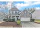 Two-story home with brick and siding exterior, front porch, and attached garage at 414 Glenview Ln, Durham, NC 27703