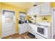 Bright kitchen with white cabinets and yellow walls at 436 Carolina Ave, Rocky Mount, NC 27801