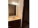 Beige bathroom vanity and mirror, with door to closet at 5629 Continental Way, Raleigh, NC 27610