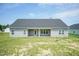 Exterior view of a home's backyard with covered patio and green lawn at 596 Ravensworth Dr, Garner, NC 27529