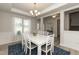 Elegant dining room with white table and blue rug at 596 Ravensworth Dr, Garner, NC 27529