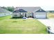 Front exterior of a two-tone home with two-car garage and landscaped yard at 596 Ravensworth Dr, Garner, NC 27529