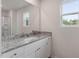 Modern bathroom with granite countertops, white cabinetry, and a large mirror at 604 Rhino Bnd, Oxford, NC 27565